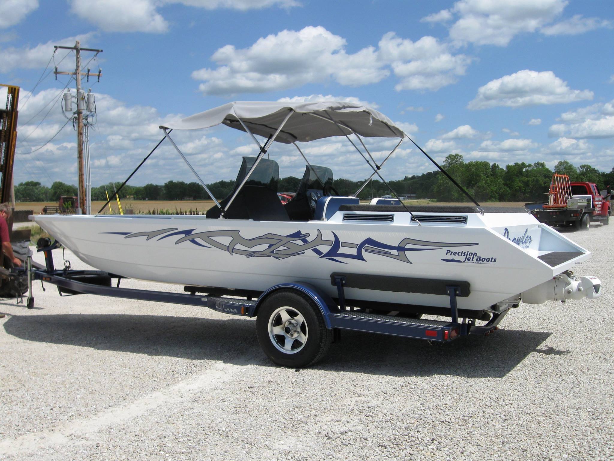 Jet boat on a trailer with custom vinyl graphics along the hull